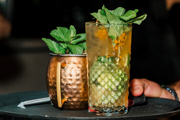African-American bartender preparing cocktails at the bar, at an afrobeats event. Nightlife, partying and bartending. Style.