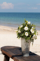 Bouquet of flowers siting on a beach in the Gulf of Mexico  