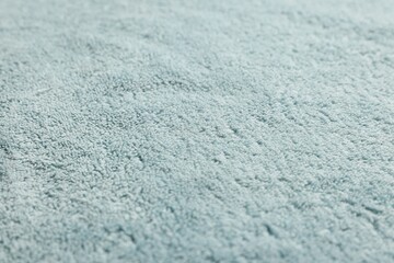 Obraz premium Soft light blue towel as background, closeup