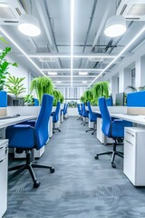 The modern and simple office space is equipped with white desks, blue chairs beside each desk