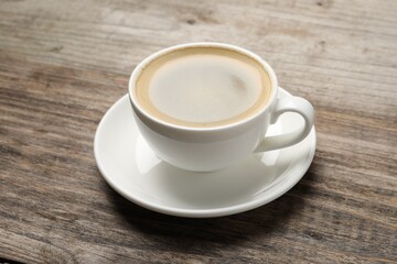 Obraz premium Aromatic coffee in cup on wooden table