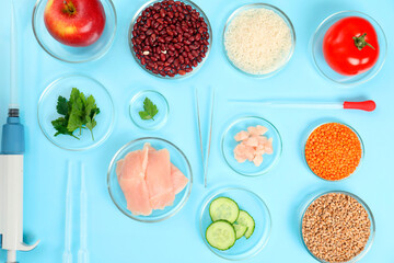 Food quality control. Petri dishes with different products, pipettes and tweezers on light blue...