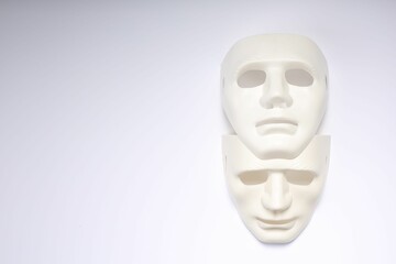 Theater arts. Two masks on white background, top view. Space for text