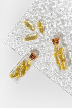 Omega 3 capsules on textured glass surface