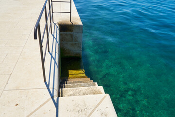 Stairs and railings on the waterfront in Zadar, Croatia.