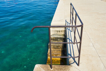 Stairs and railings on the waterfront in Zadar, Croatia.