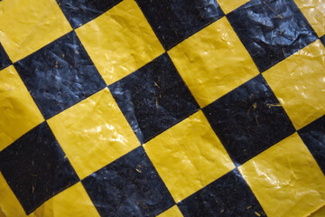 Abstract black and yellow checkerboard pattern surface background           