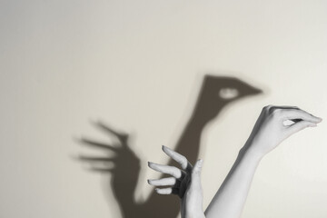 Shadow puppet. Woman making hand gesture like swan on light background, closeup with space for text. Black and white effect