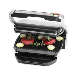 Electric grill with raw meat, zucchini and rosemary isolated on white