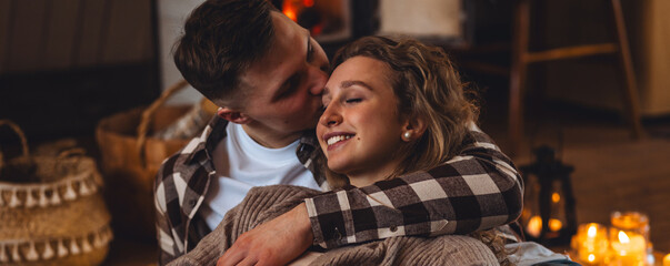 Romantic surprise for Saint Valentine's Day, christmas, new year. Weekend in the mountains in a countryside chalet house. Cozy atmosphere, relax. Candles, garlands, fireplace. Marriage proposal banner