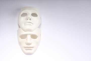 Theater arts. Two masks on white background, top view. Space for text