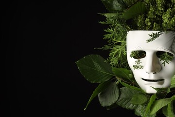 Theatrical performance. Plastic mask and floral decor on black background, space for text