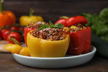 Quinoa stuffed peppers with corn and basil on wooden table