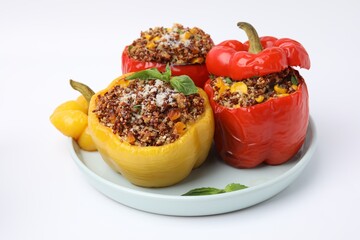 Quinoa stuffed bell peppers with corn and basil isolated on white