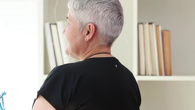 senior woman massaging her back