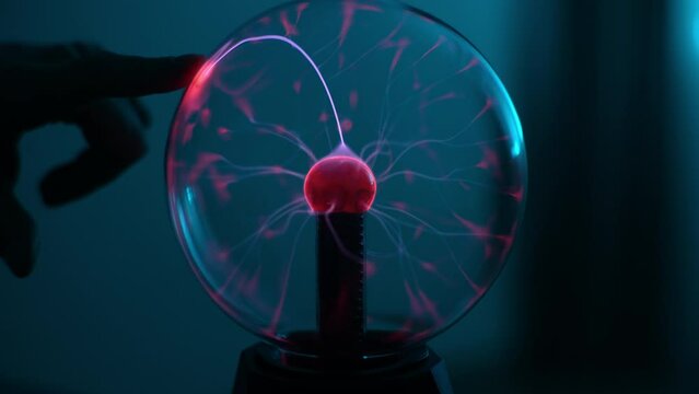 Coil experiment with electricity. Discharge lamp. Inert gas discharge tube. Closeup of Tesla lamp with high voltage lightning. Concept of science, electricity, technology, education, physics.