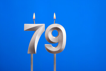 Birthday number 79 - Candle lit on blue background