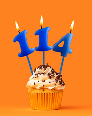 Blue candle number 114 - Birthday cupcake on orange background