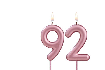 Candle number 92 - Lit birthday candle on white background