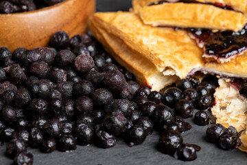 a bun and freshly frozen blueberries harvested in the forest