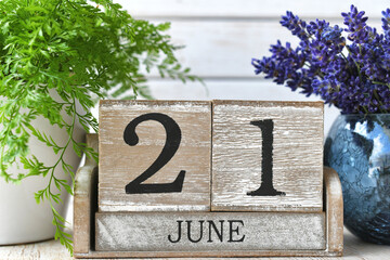 First Day of Summer aka Summer Equinox or solstice - June 21 on a wooden block calendar sitting on...