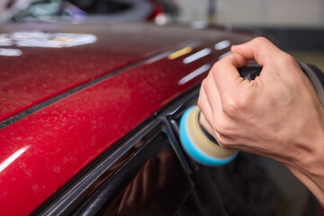Car detailing enhances shine of vehicle with machine buffer for glossy finish