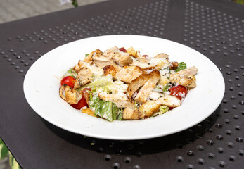 Caesar Salad, Green Lettuce Salat with Chicken and Parmesan Cheese Closeup