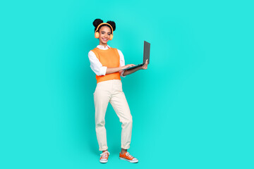 Full body portrait of nice young girl headphones laptop empty space wear vest isolated on turquoise...