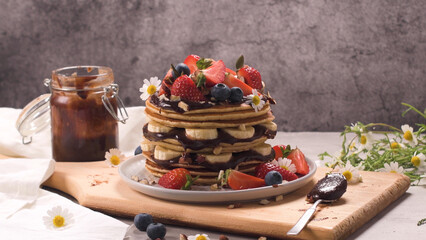 Pancakes with fruits and chocolate sauce