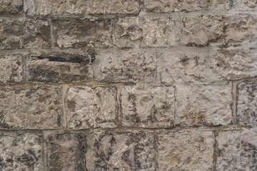 Old medieval surface made of natural stone.Part of an ancient medieval castle