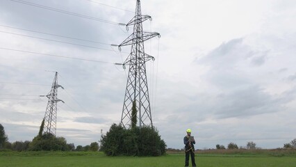 Electrical engineer using smart technology to service pylons