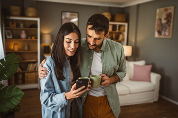 Couple use mobile phone for text message or browse internet at home