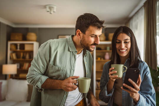 Couple use mobile phone for text message or browse internet at home