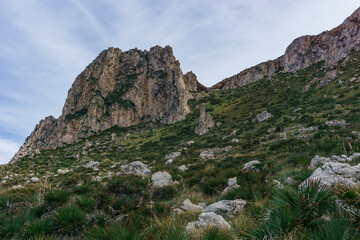View at rocky landscape with green vegetation in Nature Park of Monte Cofano at mediterranean sea, San Vito Lo Capo, Sicily, Italy