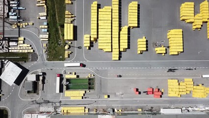Aerial view of factory plant producing autoclaved aerated concrete. Many packages of building material in blocks. Top down view of industrial area.