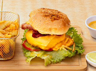 Rich burger with french fries and vegetables