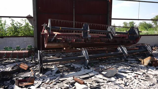 Damaged agricultural equipment on farm. Farm ruins with scattered equipment and debris. The concept of war, destruction, oblivion