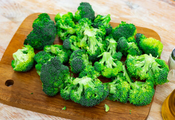 Bunch of fresh green broccoli over wooden background. Healthy vegetarian food