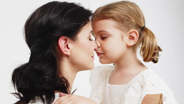 Close-up of tender touches and sensitive moment between mother and daughter. 
Happy motherhood, understanding and harmonious relationship between child and mother.