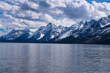 Panoramic view of Mount Teton covered with snow and lake in Wyoming, USA