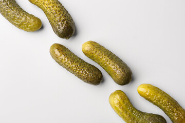 Pickled cucumbers on grey background