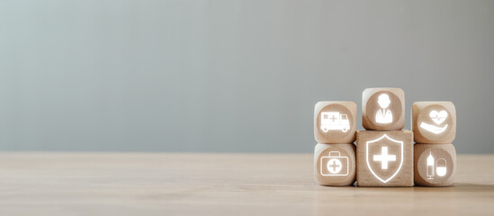 Wooden blocks with illuminated healthcare icons representing Medicare, medical services, health...