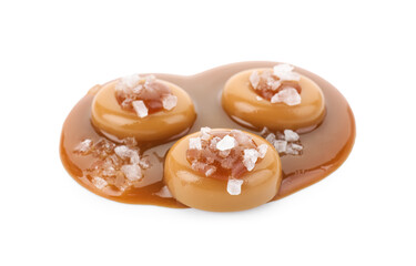 Yummy candies with caramel sauce and sea salt isolated on white