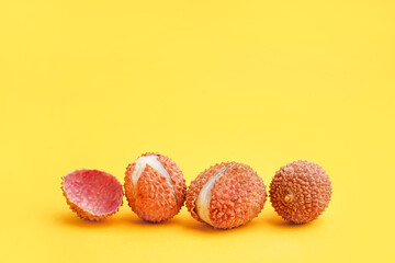 Tasty litchi fruit on orange background