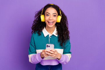 Photo of nice young girl hold phone headphones wear shirt isolated on violet color background
