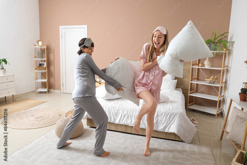 Canvas Prints young women fighting pillows in bedroom