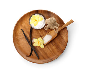 Wooden plate with vanilla powder, sugar, sticks and flowers on white background