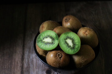 Kiwi fruit on dark background. Green Healthy organic fruit concept. 