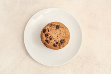Plate of sweet cookies with chocolate chips on white background