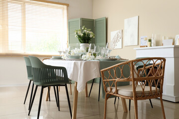 Beautiful table setting with white flowers for wedding celebration in room